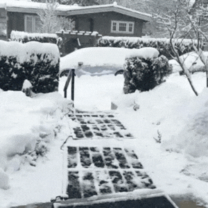 GIF showing HotStep heated mat melting snow and ice on contact, clearing a safe walkway surface in real time.